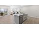 Modern kitchen island featuring stainless steel appliances and sleek grey countertops in an open-concept living space at 120 Longspur Ln, Rolesville, NC 27571