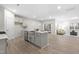 Modern kitchen with stainless steel appliances, center island, and open floor plan at 120 Longspur Ln, Rolesville, NC 27571