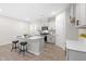 Bright kitchen features an island with bar seating and stainless appliances, and shaker style white cabinets at 120 Longspur Ln, Rolesville, NC 27571
