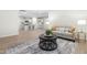 A modern living room adjacent to an open kitchen, creating a seamless, interconnected living space at 120 Longspur Ln, Rolesville, NC 27571