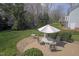 Large backyard with patio set on deck, surrounded by trees and grass at 12321 Penrose Trl, Raleigh, NC 27614