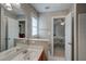 Bright bathroom featuring a sink with wood cabinets and a view to the bedroom at 12321 Penrose Trl, Raleigh, NC 27614