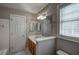 Functional bathroom showcasing a vanity with sink, mirror, and toilet near a window at 12321 Penrose Trl, Raleigh, NC 27614