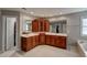 Elegant bathroom featuring dual sinks, cherry cabinets, and ample counter space at 12321 Penrose Trl, Raleigh, NC 27614