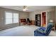 Versatile bonus room with large windows and neutral carpet. Includes a desk and bookcase at 12321 Penrose Trl, Raleigh, NC 27614