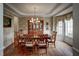 Formal dining room featuring hardwood floors, wallpaper, a window, and a chandelier at 12321 Penrose Trl, Raleigh, NC 27614