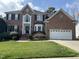 Beautiful two-story brick home with manicured lawn and attached two-car garage at 12321 Penrose Trl, Raleigh, NC 27614