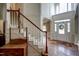 Bright foyer with hardwood floors, staircase, and a decorative front door with transom windows at 12321 Penrose Trl, Raleigh, NC 27614