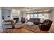 Comfortable living room with hardwood floors, fireplace, and multiple seating options at 12321 Penrose Trl, Raleigh, NC 27614