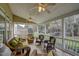 Screened porch featuring multiple seating options and ceiling fans at 12321 Penrose Trl, Raleigh, NC 27614