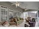Screened porch featuring multiple seating options and ceiling fans at 12321 Penrose Trl, Raleigh, NC 27614