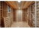 Climate-controlled wine cellar with extensive wooden racking, perfect for wine storage at 12321 Penrose Trl, Raleigh, NC 27614