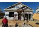 New home construction with a framing crew working on the exterior under a blue sky at 130 W Saltgrass Ln, Smithfield, NC 27577