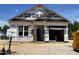 Unfinished single-story home featuring a brick pillar and an attached garage, ready for customization under construction at 130 W Saltgrass Ln, Smithfield, NC 27577