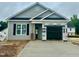 New construction home featuring gray siding, black shutters and a two-car garage with concrete driveway at 130 W Saltgrass Ln, Smithfield, NC 27577