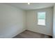 Cozy bedroom featuring neutral walls, plush carpeting, and a window providing natural light at 140 Gobbler Dr, Smithfield, NC 27577