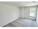 Bright, carpeted bedroom with natural light, a neutral palette, and electrical outlets for convenience at 140 Gobbler Dr, Smithfield, NC 27577