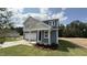 Stylish two-story house showcasing a covered entry, blue siding and an attached two-car garage at 140 Gobbler Dr, Smithfield, NC 27577