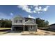 Charming two-story home with a spacious garage and a classic gray and white color scheme at 140 Gobbler Dr, Smithfield, NC 27577