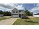 Charming two-story home with a well-manicured lawn and a red front door at 140 Gobbler Dr, Smithfield, NC 27577