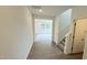 Open hallway with wood floors and a staircase, leading into a bright living space with natural light at 140 Gobbler Dr, Smithfield, NC 27577