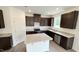 Modern kitchen featuring dark cabinetry, granite countertops, and stainless steel appliances at 140 Gobbler Dr, Smithfield, NC 27577
