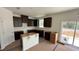 Unfinished kitchen featuring dark wood cabinets and an island, ready for personalization at 140 Gobbler Dr, Smithfield, NC 27577