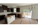 Open-concept kitchen with dark wood cabinets and a modern chandelier, offering room for customization at 140 Gobbler Dr, Smithfield, NC 27577
