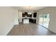 View of kitchen, dining and living area with hardwood style flooring and sliding doors at 140 Gobbler Dr, Smithfield, NC 27577
