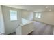 Upstairs loft area with neutral walls, cozy carpeting, and large windows providing ample natural light at 140 Gobbler Dr, Smithfield, NC 27577