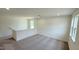 Bright upstairs loft with neutral walls, plush carpeting, and large windows providing natural light at 140 Gobbler Dr, Smithfield, NC 27577