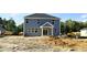 New two story home showing its rear elevation, complete with multiple windows and newly installed entry doors at 140 Gobbler Dr, Smithfield, NC 27577