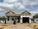 New construction home featuring an attached garage and partially completed brick exterior at 140 W Saltgrass Ln, Smithfield, NC 27577