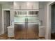 Kitchen features stainless steel appliances, custom cabinets, granite counters, and hardwood flooring at 1405 Song Bird Crest Way, Raleigh, NC 27613