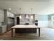 Spacious kitchen boasts an island, stainless steel appliances, custom cabinets, and hardwood flooring at 1405 Song Bird Crest Way, Raleigh, NC 27613