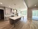 Gourmet kitchen with a large island, custom cabinetry, stainless appliances and hardwood flooring at 1405 Song Bird Crest Way, Raleigh, NC 27613