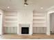 Cozy living room featuring a fireplace, custom built-ins, and hardwood flooring at 1405 Song Bird Crest Way, Raleigh, NC 27613