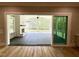 View of the screened-in patio from indoors featuring a fireplace and wooded backyard at 1405 Song Bird Crest Way, Raleigh, NC 27613