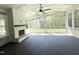 Relaxing screened-in patio featuring a cozy fireplace, ceiling fan and views of the backyard at 1405 Song Bird Crest Way, Raleigh, NC 27613