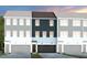 Townhome exterior featuring three units, garages, and hardiplank siding in a modern design at 1408 Chrysalis Pl, Apex, NC 27502