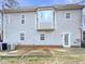 Exterior view of home's back, featuring vinyl siding, a bay window, and a patio at 143 George Wilton Dr, Clayton, NC 27520