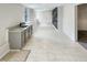 Finished basement with tile flooring, a sink area, and stylish accent wall at 143 George Wilton Dr, Clayton, NC 27520