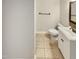This bathroom features a toilet, sink with vanity, towel bar and neutral-toned walls and tile flooring at 143 George Wilton Dr, Clayton, NC 27520