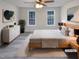 Bright bedroom featuring a ceiling fan, a light wood bed frame, and two windows that let in plenty of natural light at 143 George Wilton Dr, Clayton, NC 27520