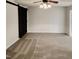 Bedroom with gray carpet, ceiling fan, and a sliding barn door at 143 George Wilton Dr, Clayton, NC 27520