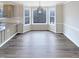 Dining room with new wood floors, modern lighting, and a bay window at 143 George Wilton Dr, Clayton, NC 27520