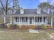 Charming single-story home with a covered front porch and a well-maintained landscaped yard at 143 George Wilton Dr, Clayton, NC 27520