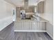 Well-appointed kitchen featuring a large island with granite countertops and a modern stainless steel range hood at 143 George Wilton Dr, Clayton, NC 27520