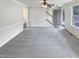 Empty living room featuring gray carpet, a ceiling fan with lighting, and an entrance to the stairwell at 143 George Wilton Dr, Clayton, NC 27520