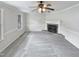 Spacious living room with a cozy fireplace and neutral carpeting, creating a blank canvas for personalization at 143 George Wilton Dr, Clayton, NC 27520